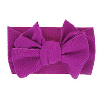 
              New-born baby's solid-colored bow headband
            